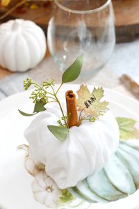 Create pretty Thanksgiving place settings with these cute napkin fold pumpkins and free printable leaf name tags